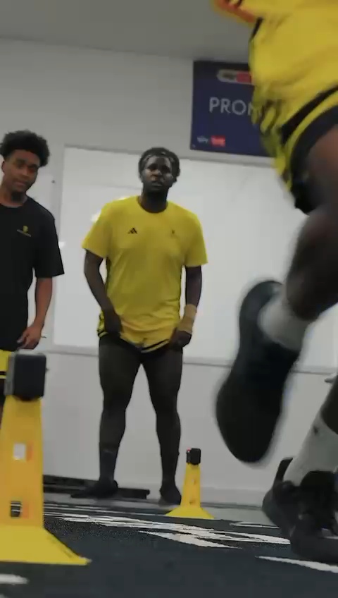 Olabanji Ibidapo sprinting through electronic timing gates during indoor speed testing